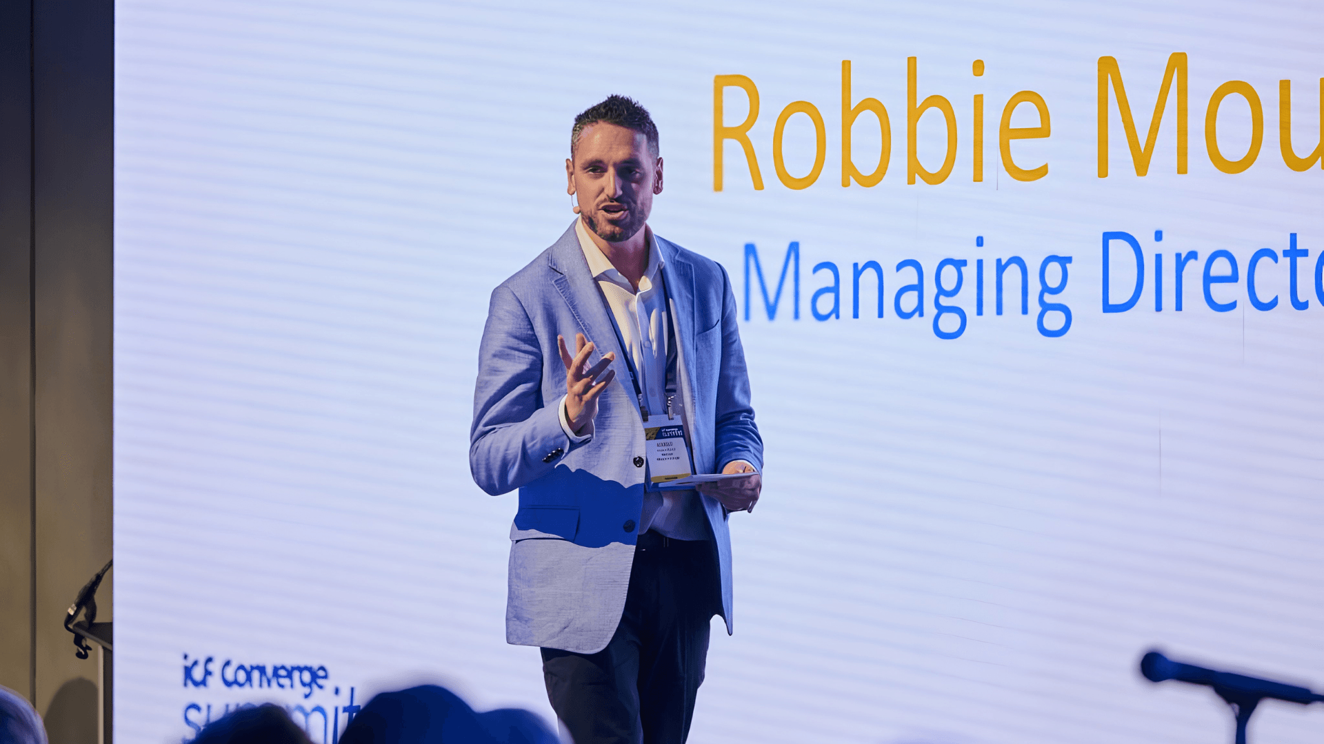 Robbie speaking on stage at the ICF Converge Summit in Paris 2026